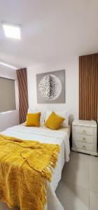 una camera da letto con un letto con una coperta gialla di P, C, Tropical Dream,1 Hab,1 Baño, Balcon, Piscina, WiFi Alta Velocidad Gratis a Punta Cana Altre 9 foto