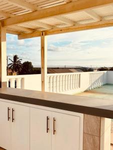a kitchen with white cabinets and a view of the beach at Los Magicos Apartments, Bonaire in Kralendijk