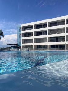a building with a swimming pool in front of a building at Hakuna Matata in San Jerónimo