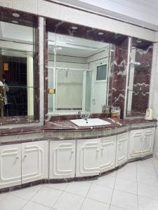 a bathroom with a sink and a mirror at Prestigious Nilefront Luxury in Cairo +32 photos