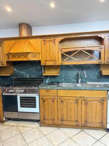 a kitchen with wooden cabinets and a stove at Prestigious Nilefront Luxury in Cairo