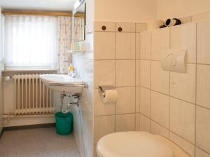 a bathroom with a toilet and a sink at Huus unner Lee 3 in Spiekeroog +20 photos