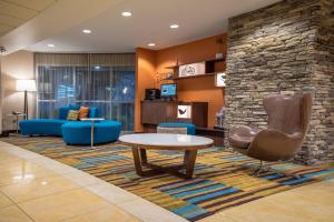 a lobby with a waiting room with a table and chairs at Fairfield Inn & Suites by Marriott Knoxville/East in Knoxville