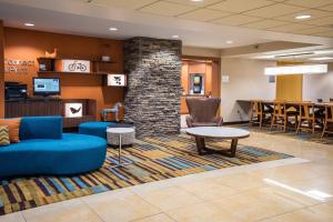 a lobby with a blue couch and chairs and a table at Fairfield Inn & Suites by Marriott Knoxville/East in Knoxville