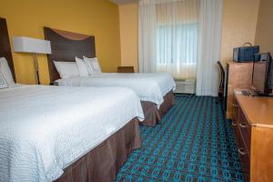 a hotel room with two beds and a television at Fairfield Inn & Suites by Marriott Knoxville/East in Knoxville