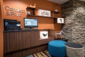 a waiting room with a computer and a blue chair at Fairfield Inn & Suites by Marriott Knoxville/East in Knoxville