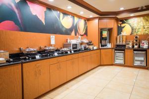 a large kitchen with wooden cabinets and appliances at Fairfield Inn & Suites by Marriott Knoxville/East in Knoxville