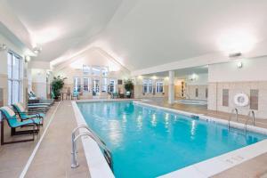a large pool with blue water in a building at Residence Inn Bismarck North in Bismarck