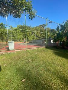 a tennis court with a fence on a tennis court at Sunny 2-bed condo - fast WIFI in Puntarenas