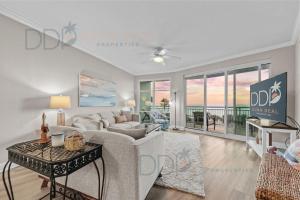 a living room with a couch and a table at Legacy Tower I 302 in Gulfport