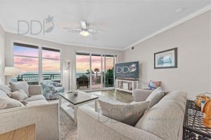 a living room with two couches and a tv at Legacy Tower I 302 in Gulfport