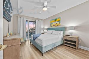 a bedroom with a bed and a ceiling fan at Legacy Tower I 302 in Gulfport +16 photos
