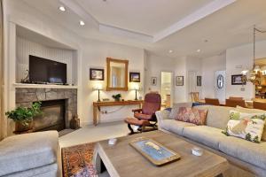 a living room with a couch and a fireplace at Lodges at Sunrise 3BR 3BA Luxury Ski On Ski Off Condo, Pool, Hot Tub, Gym, Sports Center in Killington