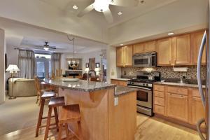a kitchen with a large island with a counter top at Lodges at Sunrise 3BR 3BA Luxury Ski On Ski Off Condo, Pool, Hot Tub, Gym, Sports Center in Killington