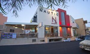 a building with a sign that reads nautica nani at Hotel Nautic in Lampedusa