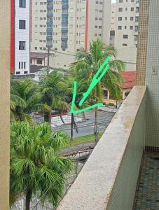 a green arrow on a ledge in a city at apartment 1 bedroom in Mongaguá