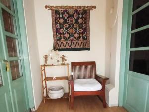a room with a chair and a tapestry on the wall at Aashaya Jasri Resort in Jasri