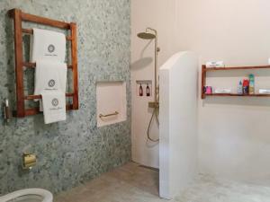 a bathroom with a shower and a toilet in it at Aashaya Jasri Resort in Jasri