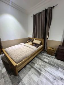 a bedroom with a bed with a curtain in it at Citrus Duplex Getaway in Dawhwenya +9 photos