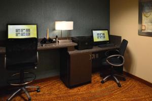 a hotel room with a desk with two computers and two chairs at Residence Inn by Marriott Akron Fairlawn in Fairlawn +7 photos