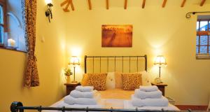 a bedroom with a bed with towels on it at The Hayloft and Bothy at the Manor House Stables - TWO units in Martin near Woodhall Spa - Dogs Welcome! in Martin