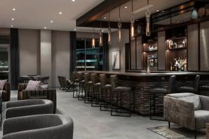 a bar in a hotel with chairs and a counter at Residence Inn by Marriott Boston Natick in Natick