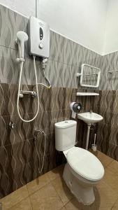 a bathroom with a toilet and a sink at Inap Renggeh Kuala Terrengganu Roomstay in Kampong Ru Sila