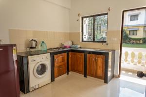A kitchen or kitchenette at 2BHK Apartment with Pool access