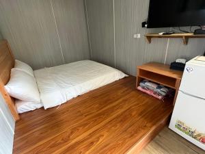 Postel nebo postele na pokoji v ubytování 夏日禾風庭園包棟