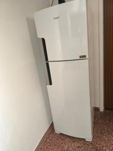a white refrigerator in a corner of a room at La casa in Gualeguaychú