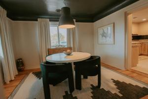 a dining room with a table and black chairs at Grandma's Old Town Adobe House! Hot Tub & Pet Friendly & No Pet Fee! in Albuquerque +48 photos