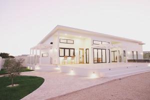 a large white house with a lot of windows at The Arv in Robe