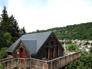 a log cabin with a porch and a deck at Chalet Mont-Dore 110m², 10 pers, parking, animaux admis - FR-1-608-280 in Mont-Dore