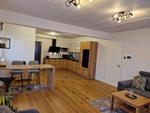 a living room with a couch and a table at Neues Wohnen in Offenburg +1 photo