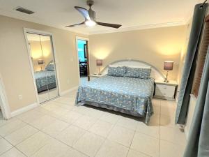 a bedroom with a bed and a ceiling fan at Sunset Villa Pool & Spa Near The Beach in Naples +13 photos