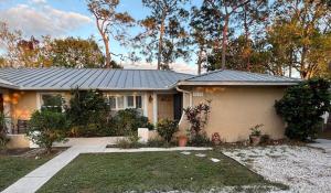 a small house with a gray roof at Sunset Villa Pool & Spa Near The Beach in Naples