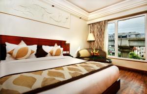 Ένα ή περισσότερα κρεβάτια σε δωμάτιο στο Hotel Regent Grand
