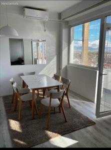 a dining room with a table and chairs and a window at Bjanka in Bitola
