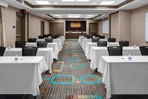 a conference room with white tables and chairs and a podium at Residence Inn by Marriott Cleveland Independence in Independence