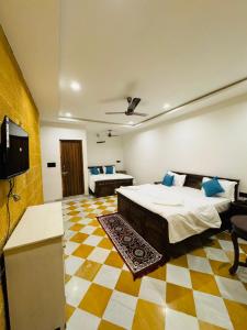 a room with two beds and a television in it at Silent Sands Jaisalmer in Jaisalmer +26 photos