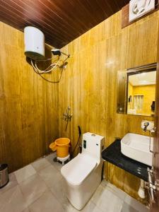 a bathroom with a toilet and a sink at Silent Sands Jaisalmer in Jaisalmer