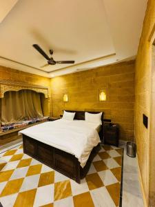 a bedroom with a bed and a checkered floor at Silent Sands Jaisalmer in Jaisalmer