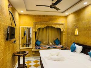 a room with two beds and a mirror at Silent Sands Jaisalmer in Jaisalmer