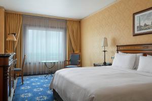 a hotel room with a bed and a table at Rome Marriott Park Hotel in Rome