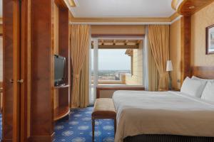 a hotel room with a bed and a large window at Rome Marriott Park Hotel in Rome