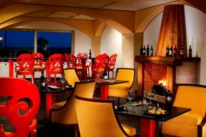 a restaurant with tables and chairs and a fireplace at Rome Marriott Park Hotel in Rome