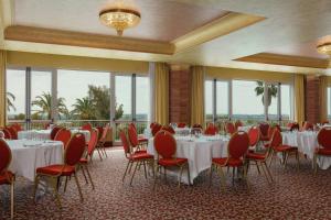 a banquet room with tables and chairs and windows at Rome Marriott Park Hotel in Rome