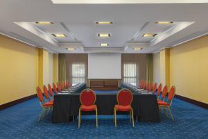 a conference room with a table and red chairs at Rome Marriott Park Hotel in Rome