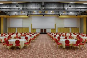 a large hall with tables and chairs and a screen at Rome Marriott Park Hotel in Rome