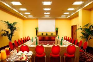 a meeting room with a long table and red chairs at Rome Marriott Park Hotel in Rome